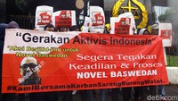 Massa membentangkan spanduk dan poster.