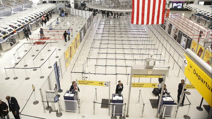The area for TSA screening of travelers at JFK airports Terminal 1 is relatively empty, Friday, March 13, 2020, in New York. The coronavirus outbreak is hitting the airline industry hard. President Trump banned most Europeans from entering the United States for 30 days to try to slow down the spread of the spread of the virus. The new travel ban is likely to further roil the airline industry as bookings decline and people cancel reservations out of fear they might contract the virus. (AP Photo/Kathy Willens)