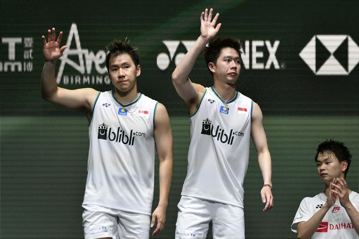 Marcus Fernaldi Gideon, Kevin Sanjaya Sukamuljo Marcus Fernaldi Gideon, left, and Kevin Sanjaya Sukamuljo of Indonesiaand wave from the podium after loosing to Yuta Watanabe and Hiroyuki Endo of Japan in the Mens Doubles final match at the All England Open Badminton tournament in Birmingham, England, Sunday, March 15, 2020. The Japanese team won 2-1. (AP Photo/Rui Vieira)