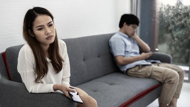 1038260916 awkward couple, issues in family concept. sad woman on sofa feeling bad with her love partner.