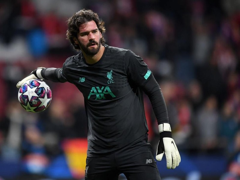 MADRID, SPAIN - FEBRUARY 18: Alisson Becker of Liverpool warms up prior to the UEFA Champions League round of 16 first leg match between Atletico Madrid and Liverpool FC at Wanda Metropolitano on February 18, 2020 in Madrid, Spain. (Photo by Michael Regan/Getty Images)