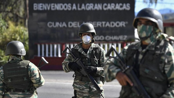 A member of the Venezuelan military take part in a military drill to block access to the countrys capital in case a spread of the coronavirus in Caracas, Venezuela, Sunday, March 15, 2020 For most people, the new coronavirus causes only mild or moderate symptoms. For some it can cause more severe illness. (AP Photo/Matias Delacroix)