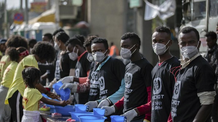 Ethiopia Virus Outbreak Volunteers stand ready to provide soap and water for participants to wash their hands against the new coronavirus at a womens 5km fun run in the capital Addis Ababa, Ethiopia Sunday, March 15, 2020. Ethiopia reported on Thursday its first case of the new coronavirus which causes COVID-19. For most people, the new coronavirus causes only mild or moderate symptoms, such as fever and cough but for some, especially older adults and people with existing health problems, it can cause more severe illness, including pneumonia. (AP Photo/Mulugeta Ayene)