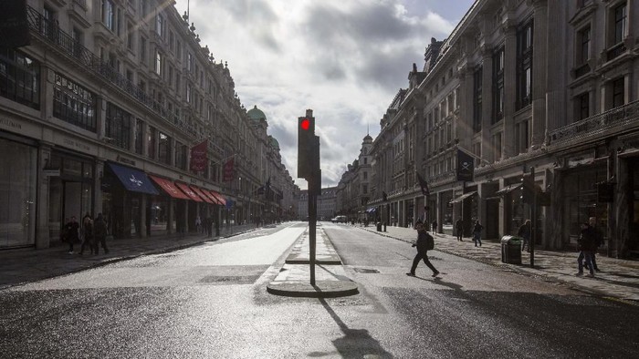 Few people stroll along a main shopping street at Regent Street after the Prime Minister said that Covid-19 is the worst public health crisis for a generation, in London Saturday March 14, 2020. For most people, the new COVID-19 coronavirus causes only mild or moderate symptoms, but for some it can cause more severe illness. (Rick Findler/PA via AP)