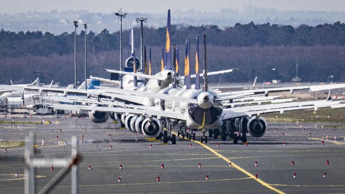 Aircrafts are parked on a runway at the airport in Frankfurt, Germany, Sunday, March 15, 2020. Due to the Coronavirus, Lufthansa had to cancel half of its flights. For most people, the new coronavirus causes only mild or moderate symptoms. For some, it can cause more severe illness, especially in older adults and people with existing health problems. (AP Photo/Michael Probst)