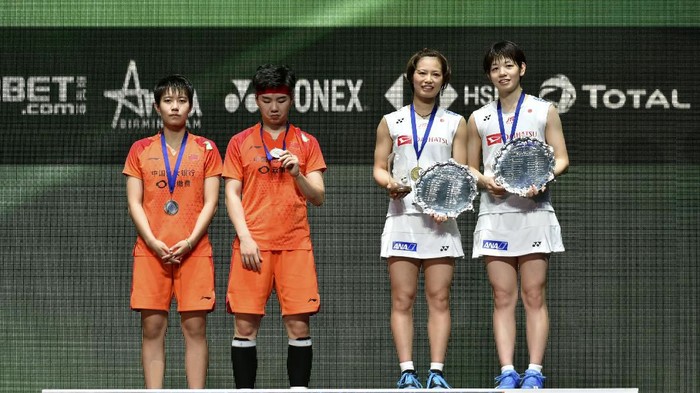 Du Yue and Li Yin Hui of China and Yuki Fukushima and Sayaka Hirota, from Japan, from left, poses with their medals after their Womens Doubles final match at the All England Open Badminton tournament in Birmingham, England, Sunday, March 15, 2020. The Japanese team won 2-0. (AP Photo/Rui Vieira)