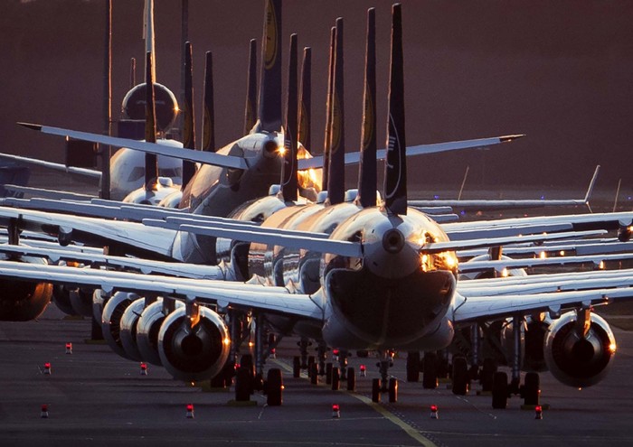 Aircrafts are parked on a runway at the airport in Frankfurt, Germany, Sunday, March 15, 2020. Due to the Coronavirus, Lufthansa had to cancel half of its flights. For most people, the new coronavirus causes only mild or moderate symptoms. For some, it can cause more severe illness, especially in older adults and people with existing health problems. (AP Photo/Michael Probst)