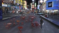 Seorang wanita berjalan di kawasan Times Square, New York, saat jama malam yang terlihat sepi.