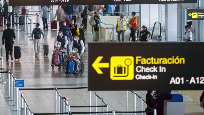 Passengers and airport workers wear protective masks as a measure to help prevent the spread of the new coronavirus, at the Tocumen international airport in Panama City, Wednesday, March 11, 2020. The vast majority of people recover from the new virus. (AP Photo/Arnulfo Franco)