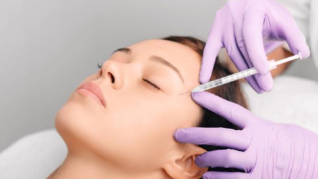 Beautiful young woman having aesthetic treatment in medical office, Corrective medicine concept