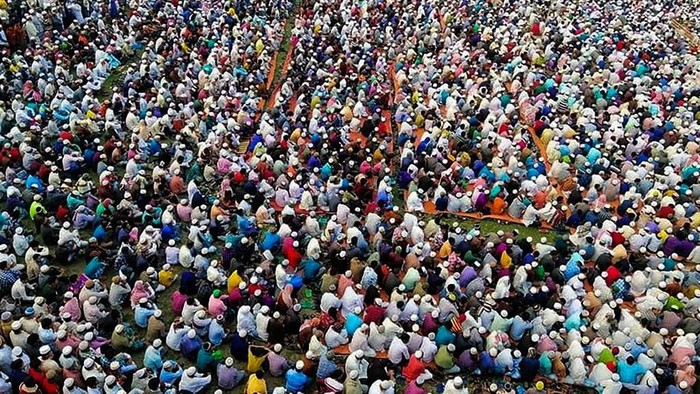 Thousands of Muslims attend a prayer session asking for safety amid concerns over the spread of the COVID-19 novel coronavirus, near Raipur in Lakshmipur district on March 18, 2020. - Thousands of Muslims have joined a special prayer in a southern Bangladesh town seeking protection from the coronavirus to almighty, officials said on March 18 as the south Asian nation confirmed its first casualty by Covid-19. (Photo by STR / AFP)