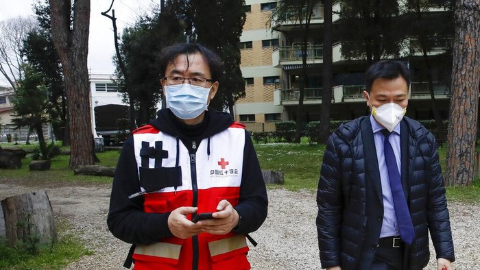 Sun Shuopeng, left, Vice President of Chinas Red Cross leaves after a press conference with Italian Foreign minister Luigi Di Maio at the Red Cross headquarters in Rome, Friday, March 13, 2020. Italy has welcomed a team of Chinese medical experts and 31 tons of ventilators, protective masks and other medical equipment as its fight against coronavirus turns a nation that usually donates aid into one that receives it. For most people, the new coronavirus causes only mild or moderate symptoms. For some it can cause more severe illness. (AP Photo/Alessandra Tarantino)