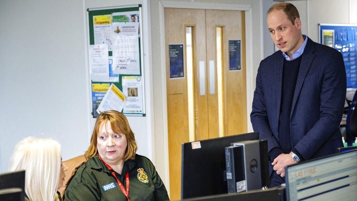 In this Thursday, March 19, 2020 photo released by Kensington Palace, Britains Prince William, centre right and Kate, the Duchess of Cambridge talk with staff,  during a visit to the London Ambulance Service 111 control room in Croydon, South London. The couple met with  ambulance staff and 111 call handlers who have been taking NHS 111 calls from the public in the wake of the coronavirus outbreak. (Kensington Palace via AP)