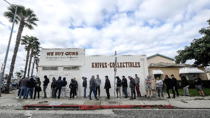 People wait in a line to enter a gun store in Culver City, Calif., Sunday, March 15, 2020. Coronavirus concerns have led to consumer panic buying of grocery staples, and now gun stores are seeing a similar run on weapons and ammunition as panic intensifies. (AP Photo/Ringo H.W. Chiu)