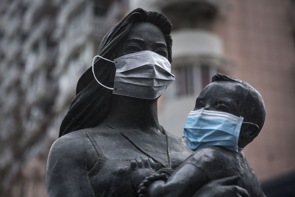 WUHAN, CHINA - FEBRUARY 10:  A protective mask is seen on a statue outside a street on February 10, 2020 in Wuhan, China. Flights, trains and public transport including buses, subway and ferry services have been closed for the nineteenth day. The number of those who have died from the Wuhan coronavirus, known as 2019-nCoV, in China climbed to 909.  (Photo by Stringer/Getty Images)