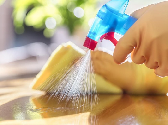 Cairan Disinfektan Cleaning with spray detergent, rubber gloves and dish cloth on work surface concept for hygiene