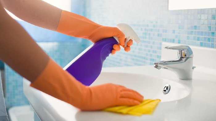 Cairan Disinfektan Cleaning with spray detergent, rubber gloves and dish cloth on work surface concept for hygiene