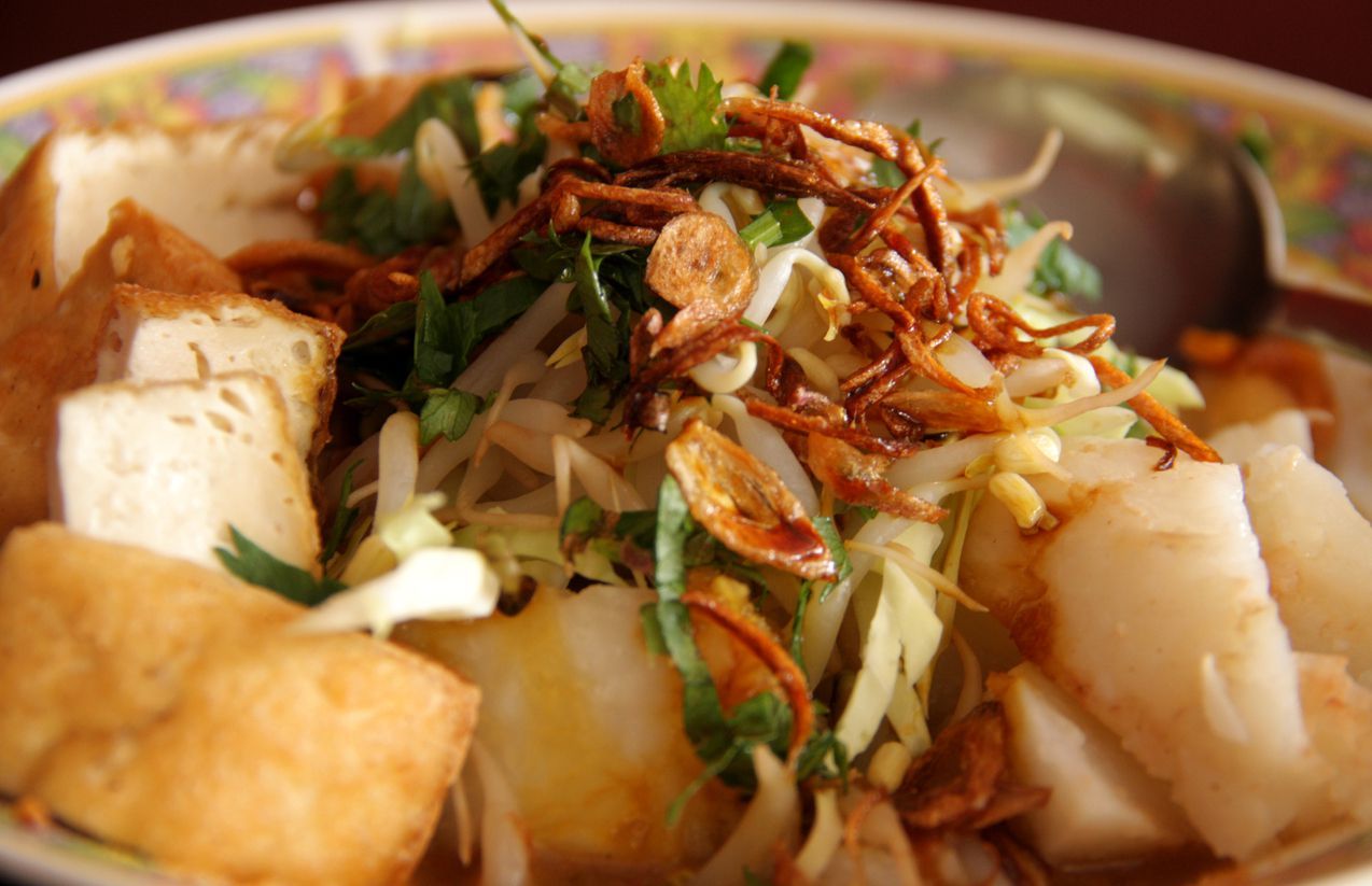 Kupat Tahu, traditional Javanese Food from Magelang, Central Java, Indonesia. The food combine tofu with rice cake, mixed with dilute peanut sauce. We can ask the spicy level.