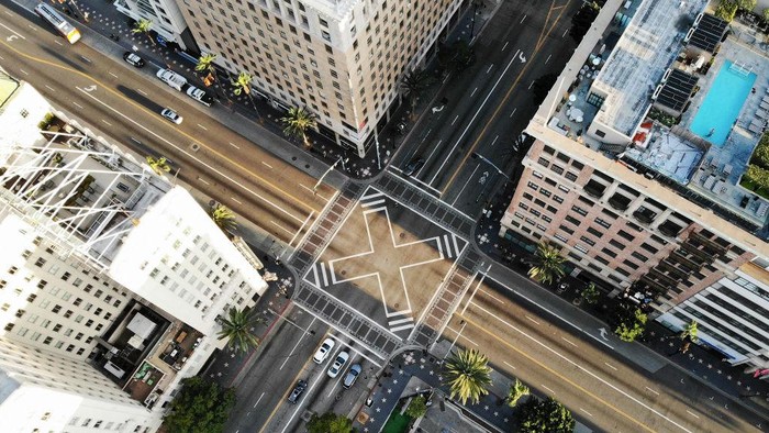 LOS ANGELES, CALIFORNIA  - MARCH 25: An aerial view shows the intersection of Hollywood and Vine, shortly before sunset, with lighter than normal traffic as the coronavirus pandemic continues on March 25, 2020 in Los Angeles, California. California Governor Gavin Newsom issued a ‘stay at home’ order for California’s 40 million residents, with exceptions for essential activities, in order to slow the spread of COVID-19. (Photo by Mario Tama/Getty Images)