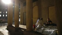 Seorang relawan memberikan perawatan kepada Tuna Wisma untuk mencegah bertambahnya korban COVID-19 di Italia. AP Photo/Antonio Calanni.