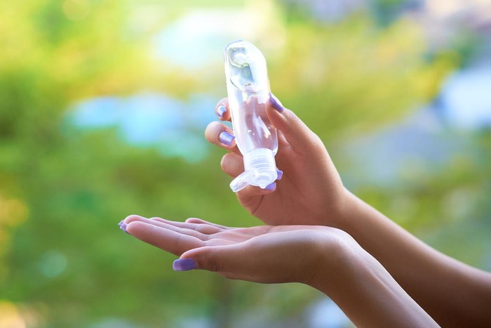 hand sanitizer Womens hands using hand sanitizer gel . healthcare and medical .
