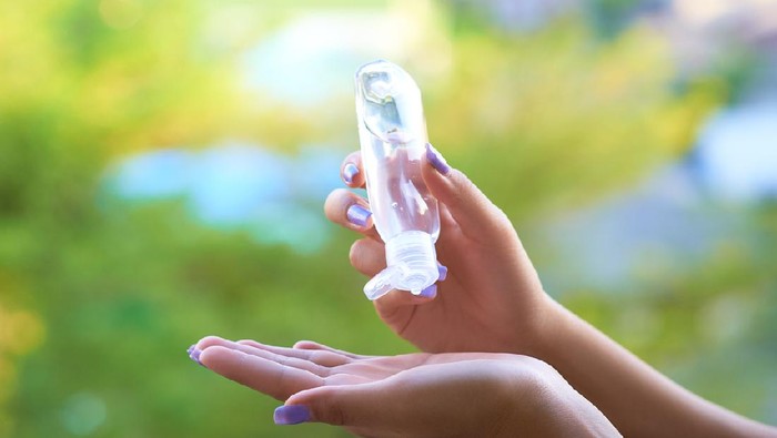 Womens hands using hand sanitizer gel . healthcare and medical .
