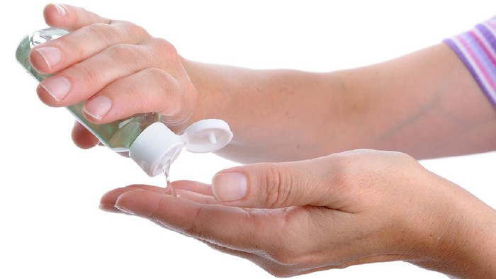 Womens hands using hand sanitizer gel . healthcare and medical .