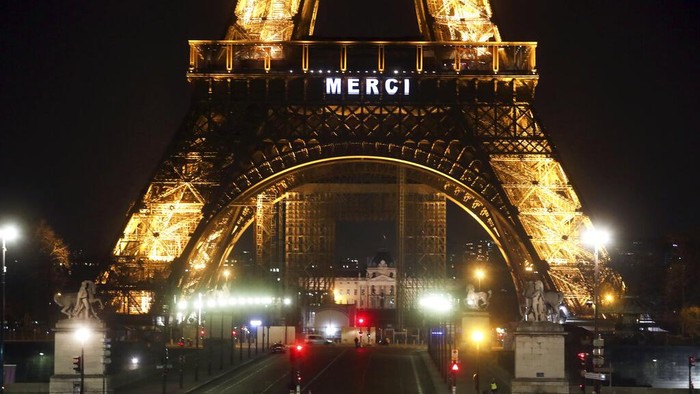 The word Merci, the French word for Thank you, is emblazoned on the Eiffel Tower as Frances coronavirus death toll continued to climb, in Paris, Friday, March 27, 2020. Health workers fighting to save lives in France from COVID-19 have received a huge show of gratitude, from the Eiffel Tower. The new coronavirus causes mild or moderate symptoms for most people, but for some, especially older adults and people with existing health problems, it can cause more severe illness or death. (AP Photo/Thibault Camus)