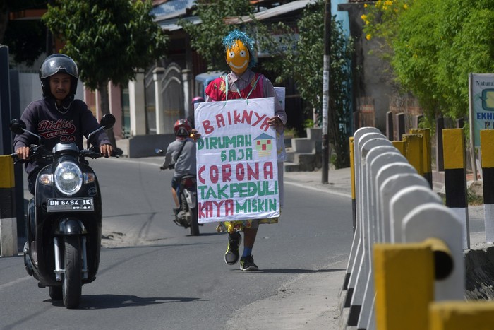 Aksi Badut Peduli Corona di Palu Seorang pria kenakan kostum badut saat berkeliling kawasan Palu, Sulteng. Hal itu ia lakukan sebagai bentuk kepedulian pencegahan penyebaran virus Corona.