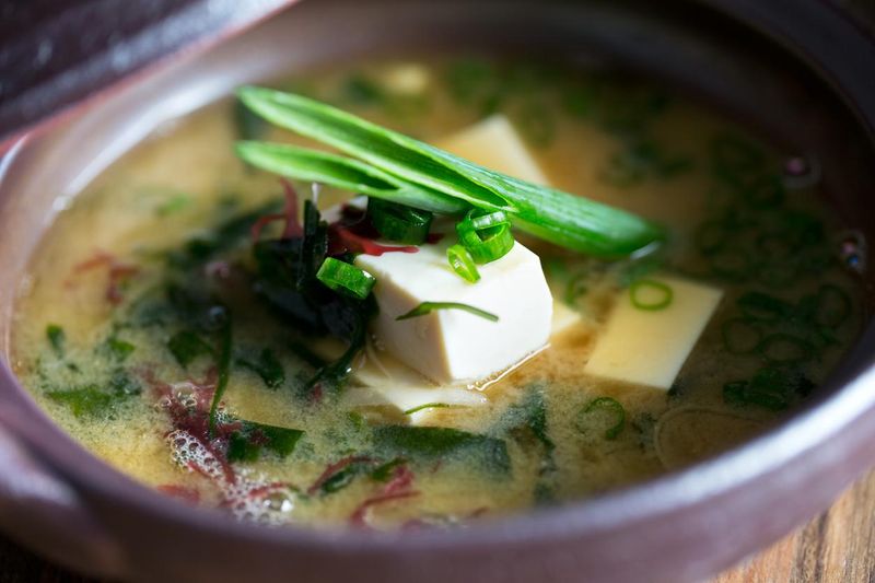 Fresh miso soup in bowl with tofu and mixed vegetables