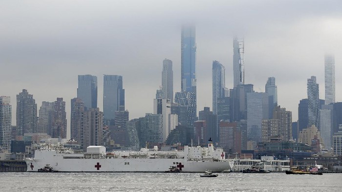 The Navy hospital ship USNS Comfort passes the Manhattan skyline on its way to docking in New York, Monday, March 30, 2020. The ship has 1,000 beds and 12 operating rooms that could be up and running within 24 hours of its arrival on Monday morning. Its expected to bolster a besieged health care system by treating non-coronavirus patients while hospitals treat people with COVID-19. (AP Photo/Seth Wenig)