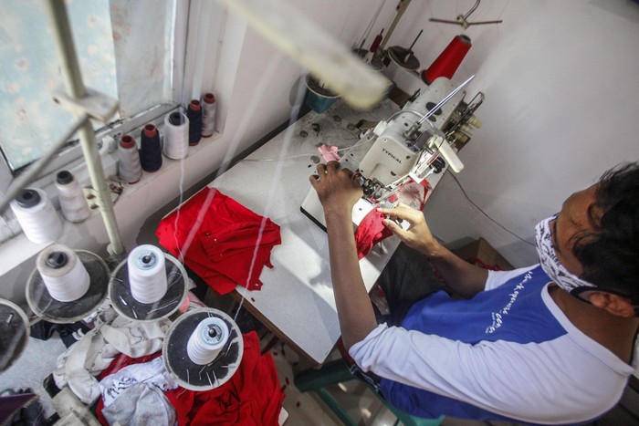 Pengrajin menyelesaikan pembuatan masker kain di Cilangkap, Jakarta Timur, Rabu (1/4/2020). Produksi masker dengan menggunakan bahan kain katun tersebut dijual seharga Rp5.000- Rp15.000 per buah dan menjadi alternatif di tengah kelangkaan dan kenaikan harga masker medis. ANTARA FOTO/Yulius Satria Wijaya/foc.