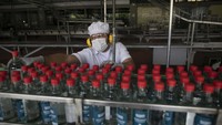 Pekerja mengisi botol-botol dengan alkohol antiseptik di pabrik rum Santa Teresa di La Victoria, Venezuela, Rabu (1/4) waktu setempat.  