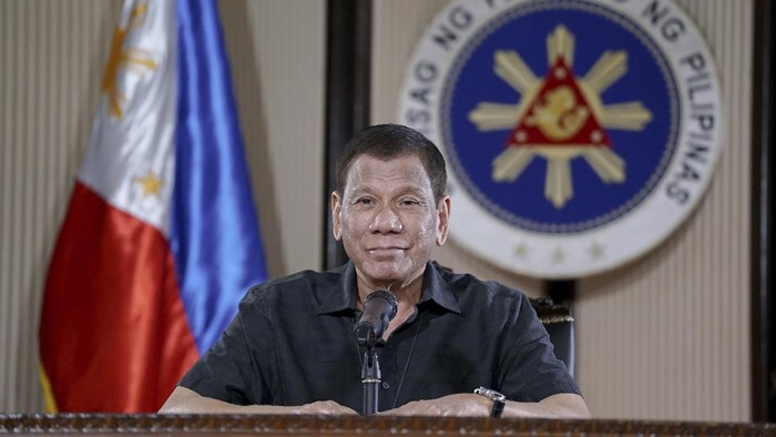 In this March 30, 2020, photo provided by the Malacanang Presidential Photographers Division, Philippine President Rodrigo Duterte smiles as he addresses the nation during a live broadcast in Malacanang, Manila, Philippines. Duterte is on quarantine for more than a week after meeting with officials who have been exposed to people infected with the coronavirus. The new coronavirus causes mild or moderate symptoms for most people, but for some, especially older adults and people with existing health problems, it can cause more severe illness or death. (King Rodriguez, Malacanang Presidential Photographers Division via AP)