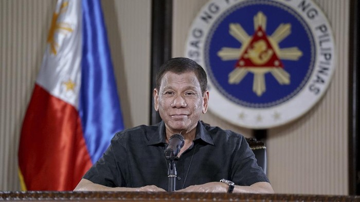 Rodrigo Duterte In this March 30, 2020, photo provided by the Malacanang Presidential Photographers Division, Philippine President Rodrigo Duterte smiles as he addresses the nation during a live broadcast in Malacanang, Manila, Philippines. Duterte is on quarantine for more than a week after meeting with officials who have been exposed to people infected with the coronavirus. The new coronavirus causes mild or moderate symptoms for most people, but for some, especially older adults and people with existing health problems, it can cause more severe illness or death. (King Rodriguez, Malacanang Presidential Photographers Division via AP)