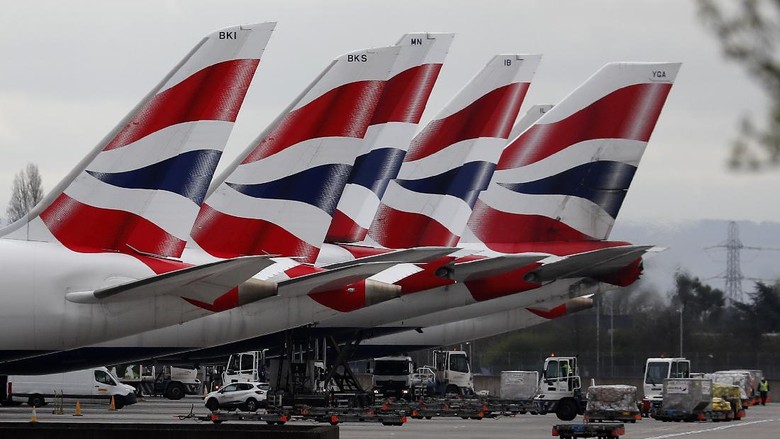 British Airways di Terminal 5 Bandara Heathrow London FILE - In this Wednesday, March 18, 2020 file photo, British Airways planes parked at Terminal 5 Heathrow airport in London. The airline has grounded much of its fleet and cabin crew, ground staff and engineers are among over 35,0000 employees facing job suspensions, it was reported on Thursday, April 2, 2020. For most people, the new coronavirus causes only mild or moderate symptoms, such as fever and cough. For some, especially older adults and people with existing health problems, it can cause more severe illness, including pneumonia. (AP Photo/Frank Augstein, File)