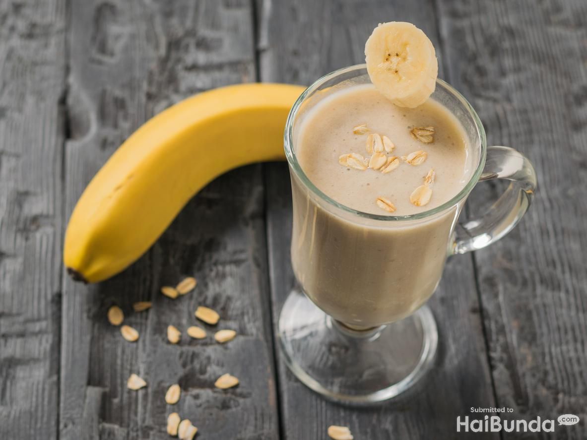 A piece of banana in a glass with a banana smoothie. Vegetarian smoothie. Sports nutrition.