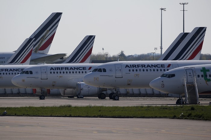 Airplanes are parked on the tarmac at the international airport of Orly, the day of its closure due to a drop in traffic, in Orly, south of Paris, Wednesday, April 1, 2020 as the government announced an extension of the initial 15-day home confinement period that came into force on March 17 in a bid to brake the spread of the Covid-19. The new coronavirus causes mild or moderate symptoms for most people, but for some, especially older adults and people with existing health problems, it can cause more severe illness or death. (AP Photo/Francois Mori)