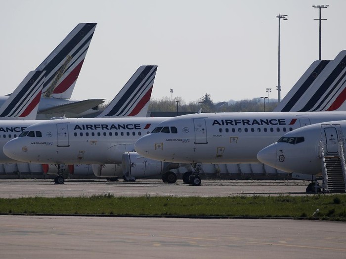 Airplanes are parked on the tarmac at the international airport of Orly, the day of its closure due to a drop in traffic, in Orly, south of Paris, Wednesday, April 1, 2020 as the government announced an extension of the initial 15-day home confinement period that came into force on March 17 in a bid to brake the spread of the Covid-19. The new coronavirus causes mild or moderate symptoms for most people, but for some, especially older adults and people with existing health problems, it can cause more severe illness or death. (AP Photo/Francois Mori)