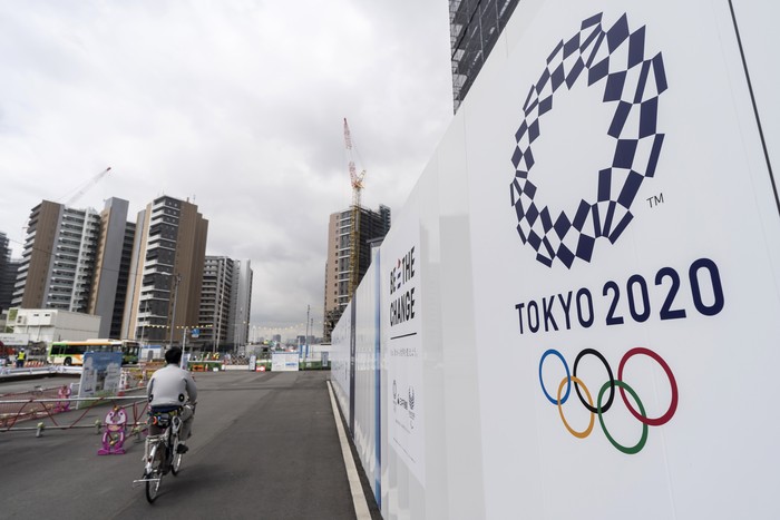 TOKYO, JAPAN - JULY 24: A worker rides a bicycle through the Olympic and Paralympic Village under construction on July 24, 2019 in Tokyo, Japan. (Photo by Tomohiro Ohsumi/Getty Images)
