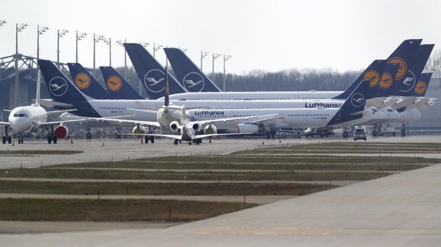 German Lufthansa planes sit parked in a line at the airport in Munich, Germany, Thursday, March 26, 2020. The planes are not in use because of the novel coronavirus outbreak. The new coronavirus causes mild or moderate symptoms for most people, but for some, especially older adults and people with existing health problems, it can cause more severe illness or death. (AP Photo/Matthias Schrader)