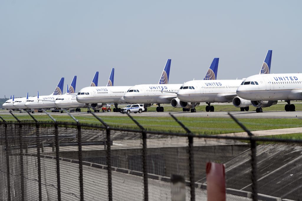 United Airlines planes are parked at George Bush Intercontinental Airport Wednesday, March 25, 2020. The airlines have reduced the number of flights flown each day as fewer people are flying due to the COVID-19 outbreak. The new coronavirus causes mild or moderate symptoms for most people, but for some, especially older adults and people with existing health problems, it can cause more severe illness or death. (AP Photo/David J. Phillip)