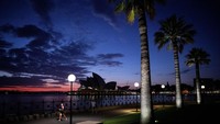 Suasana Sydney Opera House tampak sepi saat wabah COVID-19 melanda  Australia. Pemerintah Australia menggunakan istilah hibernation untuk menjelaskan apa yang mereka lakukan sekarang, yaitu dengan cara menidurkan ekonomi mereka. Getty Images/Cameron Spencer