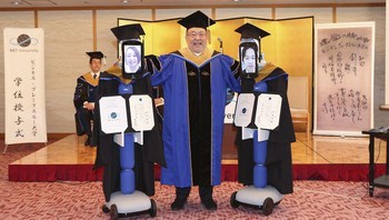 Robot “newme” yang digunakan dalam upacara tersebut memiliki tampilan yang menunjukkan wajah para lulusan yang mengendalikan mereka.