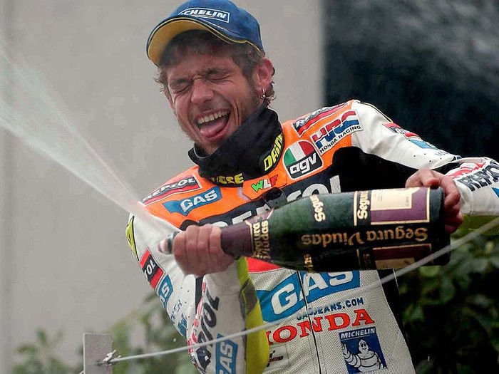 7 Apr 2002 . Valentino Rossi of Italy celebrates on the podium after winning the first round of the 500cc Motor cycle championship held at the Suzuka Circuit in Japan   DIGITAL IMAGE. Mandatory Credit: Grazia Neri/Getty Images