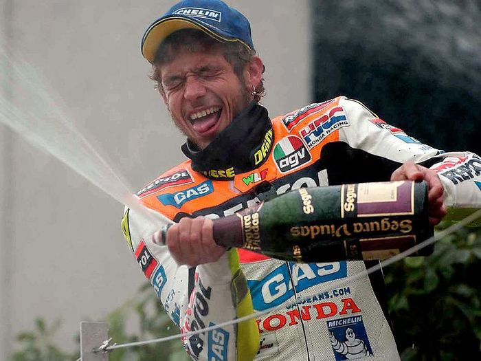 Valentino Rossi 7 Apr 2002 . Valentino Rossi of Italy celebrates on the podium after winning the first round of the 500cc Motor cycle championship held at the Suzuka Circuit in Japan DIGITAL IMAGE. Mandatory Credit: Grazia Neri/Getty Images