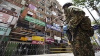 Serta penjagaan yang ketat dan adanya penerapan sanksi untuk para pelanggar karantina wilayah. AP Photo/Vincent Thian.