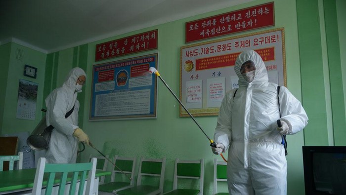 Health officials disinfect an office room amid concerns over the COVID-19 coronavirus at the Pyongchon District Peoples Hospital in Pyongyang on April 1, 2020. (Photo by KIM Won Jin / AFP) (Photo by KIM WON JIN/AFP via Getty Images)