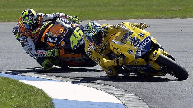 DONINGTON, ENGLAND - JULY 13:  Max Biaggi of Italy and Camel Honda leads Valentino Rossi of Italy and Repsol Honda during the Cinzano British MotoGP on July 13, 2003 at Donington Park, England. (Photo by Dan Regan/Getty Images).