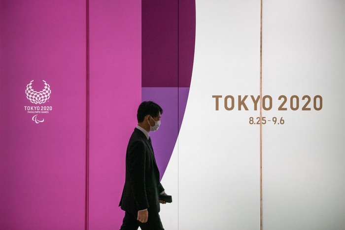 Japanese Government And IOC Agree To Postpone Olympic Games
TOKYO, JAPAN - MARCH 25: A man passes an advert for the Tokyo 2020 Olympics on March 25, 2020 in Tokyo, Japan. Following yesterdays announcement that the Tokyo 2020 Olympics will be postponed to 2021 because of the ongoing Covid-19 coronavirus pandemic, IOC officials have said they hope to confirm a new Olympics date as soon as possible. (Photo by Carl Court/Getty Images)